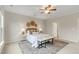 Cozy bedroom with a ceiling fan, accent decor, and a comfortable bench at the foot of the bed at 118 Manning Way, Durham, NC 27703