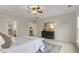 Well-lit bedroom featuring a dresser, plush bedding, and hardwood floors in the adjacent room at 118 Manning Way, Durham, NC 27703