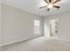 A spacious bedroom with a ceiling fan, neutral carpet and paint with a bathroom view at 118 Manning Way, Durham, NC 27703