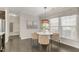 Bright dining area featuring a modern light fixture, neutral decor, and large windows at 118 Manning Way, Durham, NC 27703