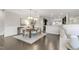 Open dining room featuring an elegant light fixture and view to the kitchen area at 118 Manning Way, Durham, NC 27703