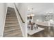 An entryway with a staircase and dining room that flows into the living room, enhancing the open-concept feel at 118 Manning Way, Durham, NC 27703