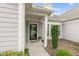 Inviting front entrance with a stylish door, decorative plants, and a covered porch area at 118 Manning Way, Durham, NC 27703