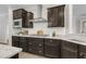Modern kitchen with stainless steel appliances, dark wood cabinetry, and bright white subway tile backsplash at 118 Manning Way, Durham, NC 27703