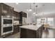 Well-appointed kitchen featuring a large island, stainless steel appliances, and dark wood cabinetry at 118 Manning Way, Durham, NC 27703