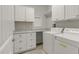 Functional laundry room with granite countertop, abundant cabinet storage, and modern washer and dryer set at 118 Manning Way, Durham, NC 27703