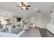 Bright and open living room with a ceiling fan and view to dining and kitchen areas at 118 Manning Way, Durham, NC 27703