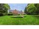 Lush backyard featuring a fountain and beautiful landscaping at 119 Georgetowne Dr, Elon, NC 27244