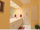 Bathroom featuring double sink vanity, large mirror, and towel closet at 119 Georgetowne Dr, Elon, NC 27244