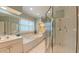 Bright bathroom featuring a soaking tub, glass enclosed shower, and double sink vanity at 119 Georgetowne Dr, Elon, NC 27244