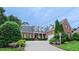 Charming brick home featuring mature landscaping and a welcoming driveway at 119 Georgetowne Dr, Elon, NC 27244