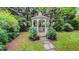 Charming gazebo surrounded by lush greenery and a stone pathway at 119 Georgetowne Dr, Elon, NC 27244