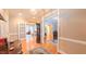 Hallway with hardwood floors and decorative rug leading to the living room with ample natural light at 119 Georgetowne Dr, Elon, NC 27244