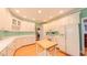Well-appointed kitchen with white cabinets, stainless steel appliances, and a functional center island at 119 Georgetowne Dr, Elon, NC 27244