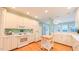Bright and open kitchen with plenty of counter space, white cabinets, and an adjacent dining area at 119 Georgetowne Dr, Elon, NC 27244