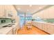 Traditional kitchen with white cabinets, wood floors, and plenty of counter space at 119 Georgetowne Dr, Elon, NC 27244