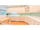 Spacious kitchen featuring white cabinetry, a wine rack, and ample counter space at 119 Georgetowne Dr, Elon, NC 27244