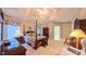 Cozy main bedroom features a tray ceiling, a floral-patterned four-poster bed, and carpeted flooring at 119 Georgetowne Dr, Elon, NC 27244