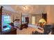 Elegant main bedroom featuring a four-poster bed, recessed ceiling and ample natural light at 119 Georgetowne Dr, Elon, NC 27244