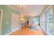 Bright sunroom adjacent to kitchen with bar seating offering scenic outdoor views and natural light at 119 Georgetowne Dr, Elon, NC 27244