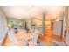 Spacious sunroom and breakfast area with hardwood floors and views into the kitchen at 119 Georgetowne Dr, Elon, NC 27244