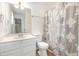 Well-lit bathroom featuring a vanity with storage, mirror, toilet and decorative shower curtain at 12 Striding Ridge Ct, Durham, NC 27713