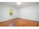 Bedroom with neutral paint, wood flooring, and ample natural light at 12 Striding Ridge Ct, Durham, NC 27713