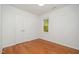 Bedroom with neutral paint, wood flooring, a closet, and natural light at 12 Striding Ridge Ct, Durham, NC 27713