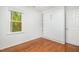 Bedroom with neutral paint, wood flooring, built-in shelving and a Murphy bed at 12 Striding Ridge Ct, Durham, NC 27713
