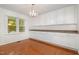 Bright dining area with hardwood floors, built-in cabinetry and a large window overlooking the lush outdoor scenery at 12 Striding Ridge Ct, Durham, NC 27713