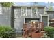 Exterior of a house with gray siding, a wood deck, and stairs leading to the yard at 120 Jo Anne Cir, Cary, NC 27513