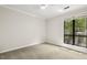 This bedroom boasts a modern ceiling fan and a large window with treetop views at 120 Jo Anne Cir, Cary, NC 27513