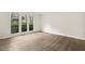 Bedroom with modern floors and three windows bringing in plenty of natural light at 120 Jo Anne Cir, Cary, NC 27513