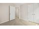 Bedroom featuring neutral carpet, a closet with double doors, and an entryway with a clear view to a bathroom at 120 Jo Anne Cir, Cary, NC 27513