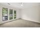 Bedroom featuring carpet, ceiling fan, and a bright view from three large windows at 120 Jo Anne Cir, Cary, NC 27513