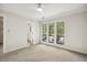 Bedroom featuring carpet, ceiling fan, and a bright view from three large windows at 120 Jo Anne Cir, Cary, NC 27513