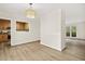 Bright dining area featuring wood floors, modern lighting, and pass-through to the kitchen at 120 Jo Anne Cir, Cary, NC 27513