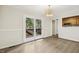 Dining room with modern flooring, double doors to outdoor deck, and open to the kitchen at 120 Jo Anne Cir, Cary, NC 27513