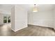Open dining area with new laminate flooring and natural light from large windows at 120 Jo Anne Cir, Cary, NC 27513