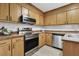 Kitchen features stainless steel appliances, wood cabinets and tile backsplash at 120 Jo Anne Cir, Cary, NC 27513
