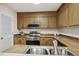 Kitchen features stainless steel appliances, wood cabinets and double sink at 120 Jo Anne Cir, Cary, NC 27513