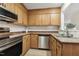 Kitchen featuring stainless steel appliances, wood cabinets and tile backsplash at 120 Jo Anne Cir, Cary, NC 27513