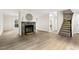Living room features stone fireplace, modern flooring and staircase to the right at 120 Jo Anne Cir, Cary, NC 27513