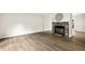 Bright living room features stone fireplace and modern flooring at 120 Jo Anne Cir, Cary, NC 27513
