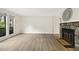 Bright living room features stone fireplace, modern flooring and large windows at 120 Jo Anne Cir, Cary, NC 27513