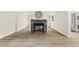 Bright living room features stone fireplace and modern flooring, laundry room to the right at 120 Jo Anne Cir, Cary, NC 27513