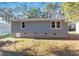 View of the backyard and home's rear, showing simple landscaping at 1211 Freeman Dr, Sanford, NC 27330