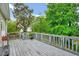 Spacious back deck overlooks the backyard with mature trees, perfect for outdoor entertaining at 1216 Miracle Dr, Wake Forest, NC 27587