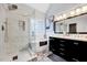Bright bathroom includes a glass enclosed shower, soaking tub, and modern vanity at 1216 Miracle Dr, Wake Forest, NC 27587