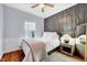 Guest bedroom includes a stylish accent wall, plush rug, and bright window at 1216 Miracle Dr, Wake Forest, NC 27587